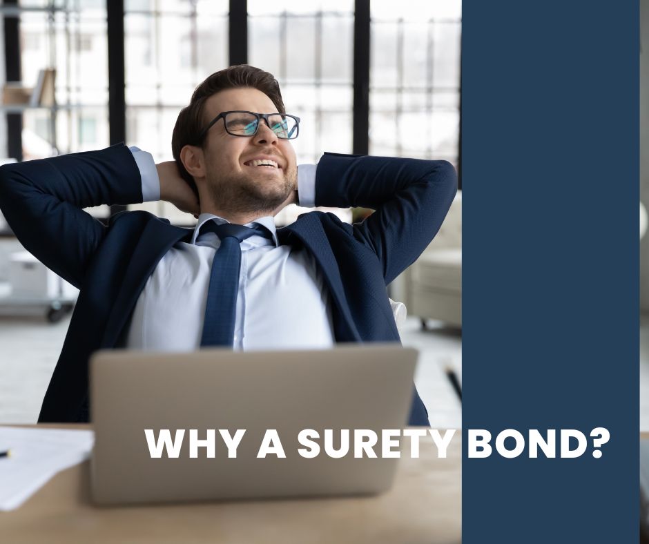 Why a Surety Bond? - A surety agent working at the office. Doing some stuff on his laptop.